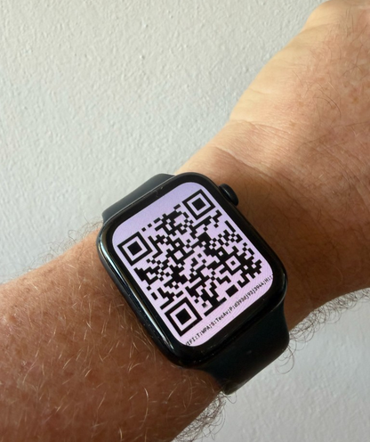 Apple Watch on a wrist showing a full-screen QR code