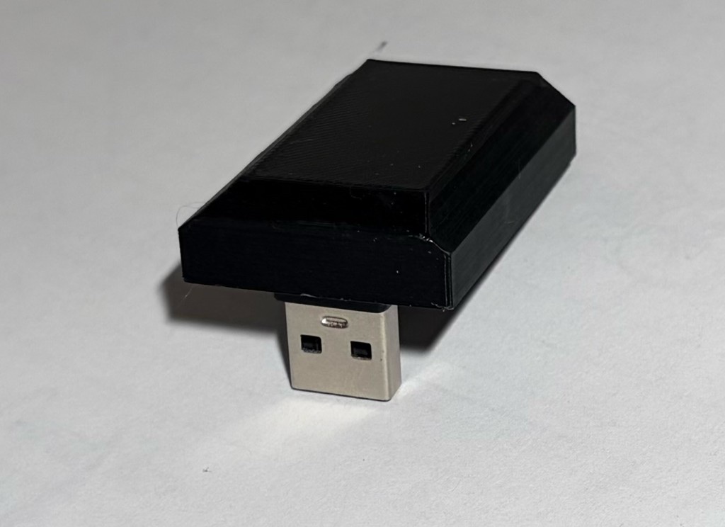 Flux Drive — a small black device with a USB-A plug