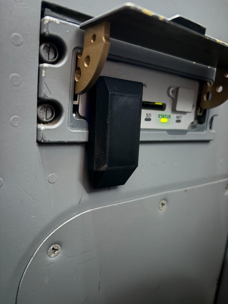 Flux Drive plugged into the FMS data loader USB port in an aircraft